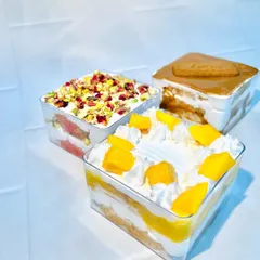 A trio of my delicious cake tubs. This picture shows my seasonal mango cake tub, the popular rose pistachio tub, and the indulgent Biscoff tub. There's a flavor for every mood.