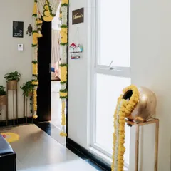A beautiful housewarming decoration for an apartment entrance. I used traditional marigold and tuberose flower garlands to create an auspicious and welcoming entryway.
