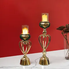 For a more modern look, these candle stands feature a unique heart-shaped metal frame in gold, paired with a deep green ceramic accent. They are a stylish and contemporary way to add candlelight to your home.