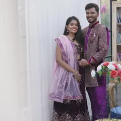 A full-length view of the matching purple lehenga and sherwani set. Renting a coordinated outfit like this ensures a picture-perfect look for your couple's photoshoot.