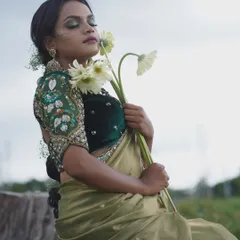 This unique blouse features bird-motif embroidery on the puffed sleeves, set against a dark green velvet body. It’s a perfect example of how I blend traditional motifs with contemporary design for a standout look.
