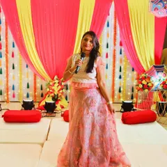As an emcee, my job is to bring the party to life. Here I am, microphone in hand, hosting a lively Mehndi and Ganesh Pooja function. I ensure the event flows smoothly with engaging games and a vibrant atmosphere that gets everyone involved.