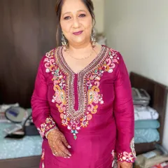 A mother's glow on her son's wedding day is truly special. I created a sophisticated look with a mauve lip and soft eye makeup that complemented her richly embroidered magenta suit.