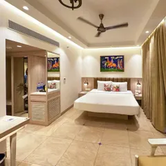 A full view of a guest room at our recently completed project in Candolim, Goa. The room features a floating bed design, clean lines, and a neutral palette accented by colorful local artwork.