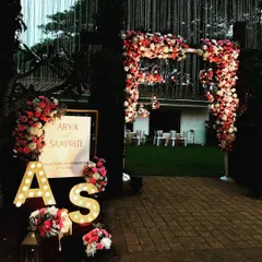 A personalized welcome entrance for a wedding reception. I created a lush floral arch and arranged flowers around the couple's initials in large marquee letters.