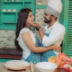 Love is cooking up something beautiful! This couple shares a laugh in a quirky kitchen setting, a perfect example of a themed pre-wedding shoot that reflects shared interests and creates fun, natural interactions.