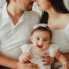 Pure happiness in one frame. This candid family portrait captures the loving gazes and bright smiles that make these moments unforgettable.