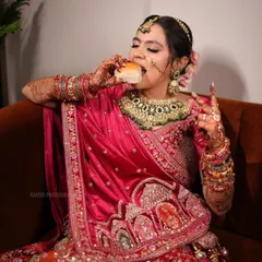 Another angle of the bride taking a quick bite, capturing a relatable and humorous moment on a long wedding day.