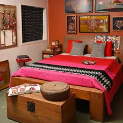Another view of the bedroom makeover, showing how the different textile elements, from the throw to the cushions, create a cohesive and inviting "boho living" aesthetic.