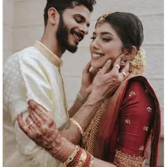A tender moment between the bride and groom during their Kerala wedding ceremony, filled with genuine smiles and affection.