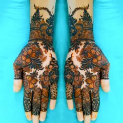 Symmetrical beauty. Both hands are decorated with a dense pattern of flowers and leaves, creating a mirror-image look.
