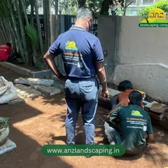 Our crew works diligently on soil preparation, ensuring a solid and nutrient-rich foundation before laying down the pathway stones and turf.