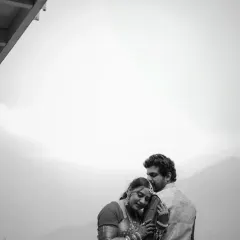 A timeless black and white portrait that focuses purely on emotion. The groom's gentle embrace and the bride's peaceful expression tell a story of comfort and love.