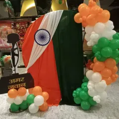 To add a deeper meaning to a patriotic event, I created this display with an Amar Jawan Jyoti cutout. The combination of tricolor fabric draping and a matching balloon garland makes for a respectful and visually striking decoration.