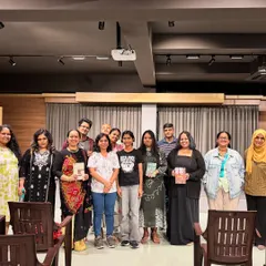 A happy group of participants and organizers posing together after a successful literary event.