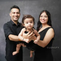 A classic family portrait against a simple backdrop. The focus is entirely on the family and the bond you share.