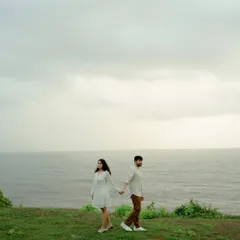 A creative shot of the couple on a cliff overlooking the sea in Goa. The composition creates a sense of anticipation and adventure, perfect for a pre-wedding story.