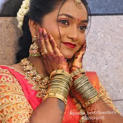 A joyful moment captured. This bride is wearing a beautiful antique gold set with matching bangles, perfect for her wedding ceremony.