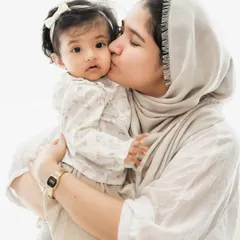 The gentle love of a mother's kiss. We focus on capturing these simple, profound gestures of affection during our family photoshoots.