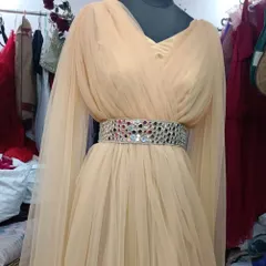 A closer look at the Golden Angel gown, showing the draped net fabric and the embellished mirror-work belt. It's a lightweight yet impactful outfit.