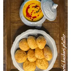 My Karhi Kachori platter features flaky kachoris served with a tangy and spicy yogurt-based curry. It's a traditional Rajasthani snack that I love to prepare for festive gatherings.