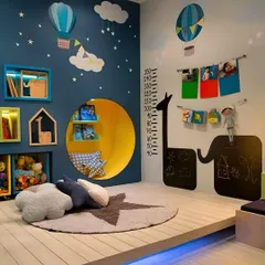 A whimsical playroom and bedroom featuring a cozy reading nook built into the wall, a growth chart decal, and chalkboard panels for endless creativity.