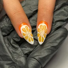 A macro shot of the hand-painted orange slice nails. I used different shades of orange and white to create a realistic, juicy effect.