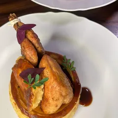 Caille En Sarcophage, or "Quail in a Coffin." A classic French dish where a pan-roasted quail is presented in a crisp, buttery vol-au-vent with a marjoram jus.