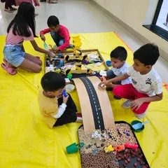 My setups are perfect for birthday parties, encouraging kids to play together and share. Here, a group of friends are completely engaged in our transportation theme, pouring, scooping, and driving cars down the ramp.