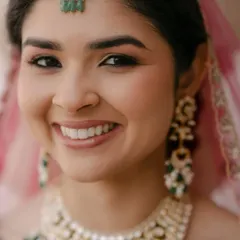The essence of my philosophy is makeup that enhances, not masks. This close-up shows the soft glam look I love: luminous skin, subtly defined eyes with a warm, neutral shadow, and perfectly groomed brows. It’s about looking like the best version of yourself.