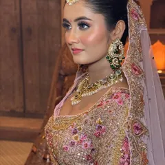A side profile that captures the beautiful contour and highlight on the bride's cheekbones, adding a touch of glamour to her soft look.