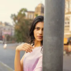 A creative composition that uses the street pole to frame the model's face, creating a sense of mystery and intrigue.