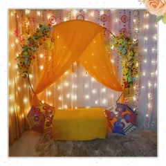 What's a desi wedding without a little rang and dhamaal? This colorful setup with yellow drapes, fairy lights, and traditional umbrellas is perfect for a Mehendi or Haldi function.