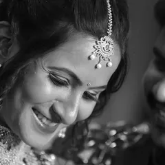 For us, it's all about the real emotions. This candid, black and white shot captures a genuine moment of joy and connection between the couple during their wedding celebration.