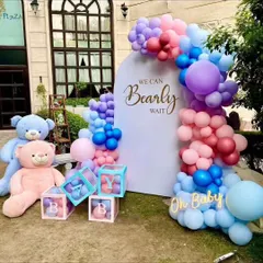 For this baby shower, I designed a "We Can Bearly Wait" theme with a beautiful balloon arch in shades of pink, purple, and blue. The setup includes large teddy bears and transparent "BABY" blocks filled with matching balloons.