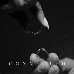 A powerful and symbolic black and white shot of the engagement rings, held apart but "Connected." This image represents the union of two souls.