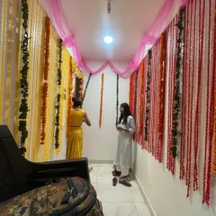A beautiful and traditional flower decoration for a housewarming ceremony (Griha Pravesh). I used strings of marigold and other flowers to create a welcoming and auspicious entrance.