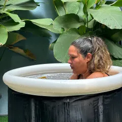 Finding focus in the cold. A member bravely embraces the invigorating challenge of a cold plunge, a key part of our recovery and wellness offerings.