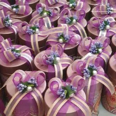 For a traditional yet elegant *baraat swagat*, we offer these beautifully decorated favor boxes. The rich purple and gold packaging adds a touch of royalty to your welcome gifts.