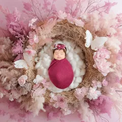 There is nothing as pure and peaceful as a sleeping newborn. For this newborn portrait, I created a delicate nest of pink flowers and soft textures to keep this little angel cozy and safe.