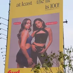 The corresponding billboard for the denim look, showcasing how the subtle makeup enhances the models' features without distracting from the fashion.