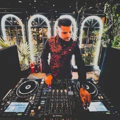 A moodier shot from a wedding performance. The lighting and my focus on the mixer highlight the technical side of my craft, ensuring every transition and track selection is perfect for the moment.