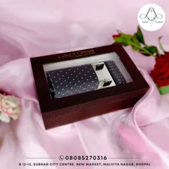 A beautifully packaged accessory set, featuring a navy blue polka dot tie, matching pocket square, and elegant cufflinks. This is the perfect way to complete your custom suit or to give as a thoughtful gift.