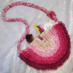 This retro-style bag has so much personality with its fun loop stitch texture and ombre pink colors. It's surprisingly spacious, perfect for carrying your sunglasses, lip balm, and other essentials, and is fully lined with satin.