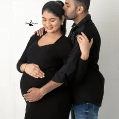 A sweet kiss on the head while he cradles her and the baby bump. Even in casual clothes, the love and emotion are powerful and clear.