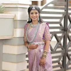 I help you achieve that perfect modern bridal look. Here, we styled a gorgeous American Diamond layered necklace set with emerald-green stones to match this bride's reception lehenga, creating a look that's both glamorous and sophisticated.