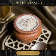 Indulge in the creamy goodness of our Rabdi. This classic Indian dessert is made by simmering milk for hours until it thickens, then sweetened and flavored with cardamom and saffron.