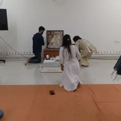 Seekers bowing in gratitude before the Sadhguru Sannidhi after a puja. The feeling of grace in the room is palpable, a shared experience for the entire spiritual family.