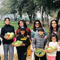 A happy group of families and friends with their harvest. Our farm is the perfect backdrop for group outings, creating shared memories in a natural setting.