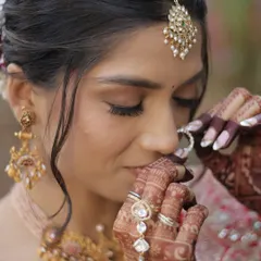A close-up on the details of a traditional bridal look. Notice the soft brown eyeshadow that defines the eyes without overpowering them, paired with finely groomed brows and a matte skin finish for a sophisticated look.